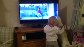 Dog and toddler watch John Lewis Christmas advert together