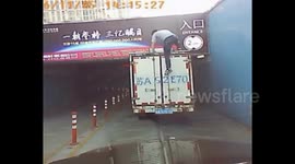 Lorry slides into garage when driver stands on the top