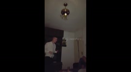 Man smashes light bulb while opening bottle of champagne