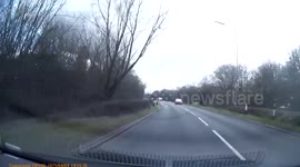 VOLUME WARNING. Young men in pants walking down the road. With audio from the ladies in the car!