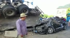 Cement tanker flips over and squashes car