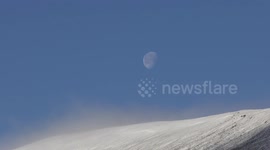Remains of supermoon visible in daylight over snow covered Scottish mountains 18th Nov 2016