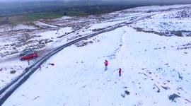 Child Playing In Sleigh On Snow - Aerial Video