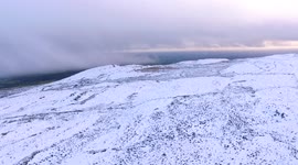 Amazing bird's-eye view of snow covered mountain in Northern Ireland