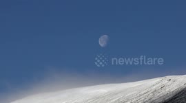 Supermoon over snow covered Scottish mountains during daylight AM 18th Nov 2016