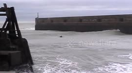 Surfers ride waves off Brighton coast during Storm Angus