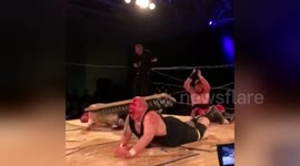 Newsflare Edit - Wrestler jumps off scafold onto bed of nails on top of opponent