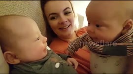 Twin baby girls notice each other for the first time