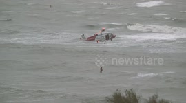 Woman dies after rescue helicopter winches her from sea during storm