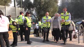 Elderly people evacuated by police and taken to public shelters in Haifa, Israel.