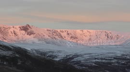 Beautiful sunrise over snow-covered mountains in Scotland