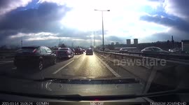 Dash cam - man running across motorway to recover blown out tyre