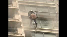 Four 'spider men' rescue residents trapped in skyscraper on fire