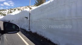 Car passing through extremely deep snow