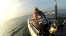 Kayak angler hooks huge fish