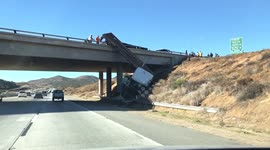 18-wheeler truck falls off bridge onto California highway