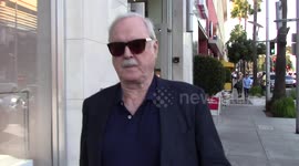 John Cleese tells the paparazzi what he thinks of Donald Trump