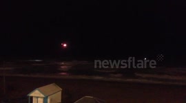 Helicopter and lifeboat searching for person in the sea next to Brighton Pier.
