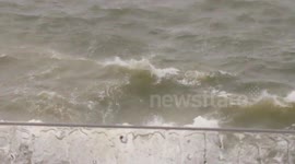 Man swimmimg in sea during strom in plymouth