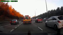 Dashcam: Roadworker hangs on side of moving vehicle.