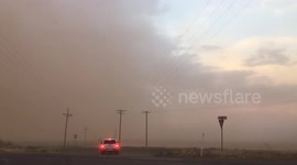 Tumbleweeds fly as drivers flee massive dust storm