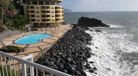 Relax in the swimming pool during sea storm