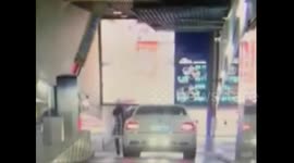 Car sliding down slope smashes wall