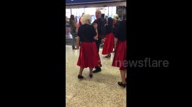Newsflare Edit - Baby utterly enthralled by singers in supermarket