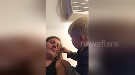 Toddler tries to wake up mum with kisses
