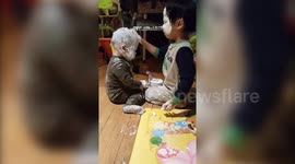 Naughty toddlers left alone cover their face in nappy rash cream