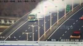 Heavy smoke comes out of coach driving on motorway