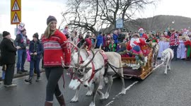 Merry Christmas with Reindeer pulling Santa through Dunkeld Perthshire Scotland
