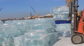 Workers begin harvesting ice for massive snow festival in China