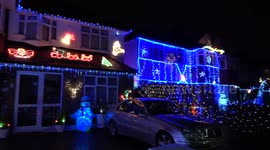 Residents decorate London street in festive lights for charity