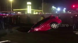 Car falls into small sinkhole in China