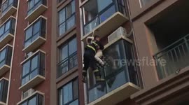 Firefighter rescues a young woman trying to jump from a building
