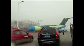 Newsflare Edit - Large military aircraft crossing road causes traffic jam