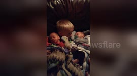 Toddler holds twin brothers for the first time and won't let them go