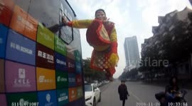 Man hangs off side of coach in 'Monkey King' costume