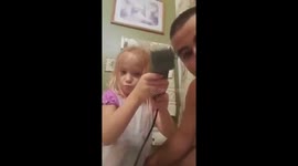 Daughter shaves Daddy's hair.