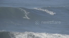 Andrew Cotton surfs monster wave at Nazare, Portugal