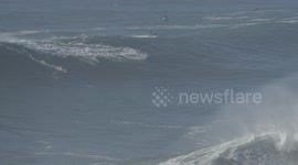Pro surfer wipes out on XXL wave at Nazare Portugal