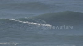 Pro surfer wipes out on huge XXL wave at Nazare Portugal