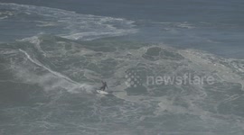 Pro surfer wipe out on XXL wave in Nazare Portugal