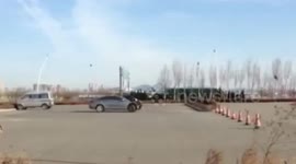 Mechanic lies on car while it moves to repair it