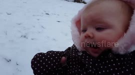 Baby eats snow for the first time and loves it