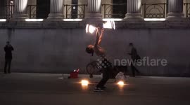 Fire eating busker Trafalgar Square,London,UK