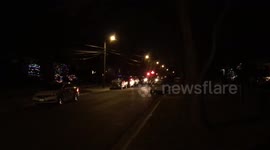 Santa Claus greets adults & child on an antique fire truck