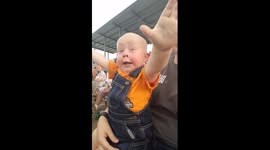 15-month-old baby gets incredibly excited about live motor racing