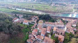 Aerial shot, a small town in the middle of the fall nature in Italy, Tuscany, filmed with drone